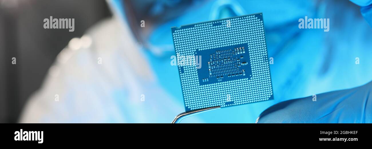 Scientist developer in protective suit holds microcircuit Stock Photo
