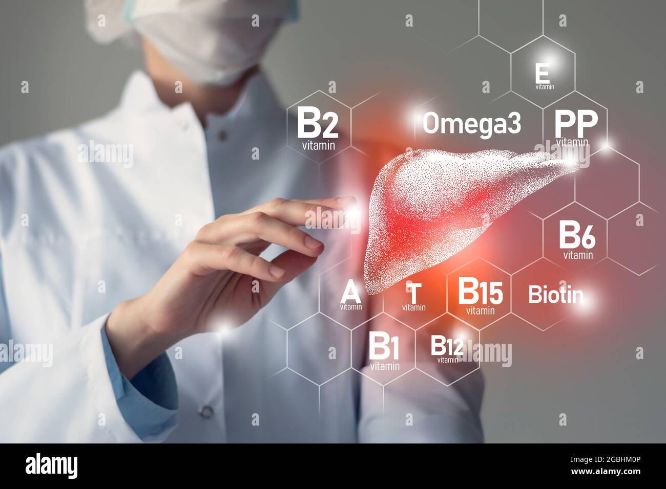 Essential nutrients for Liver health including Omega-3, Carnitine, Biotin, Vitamin PP, Vitamin B. Blurred portrait of doctor holding highlighted red L Stock Photo