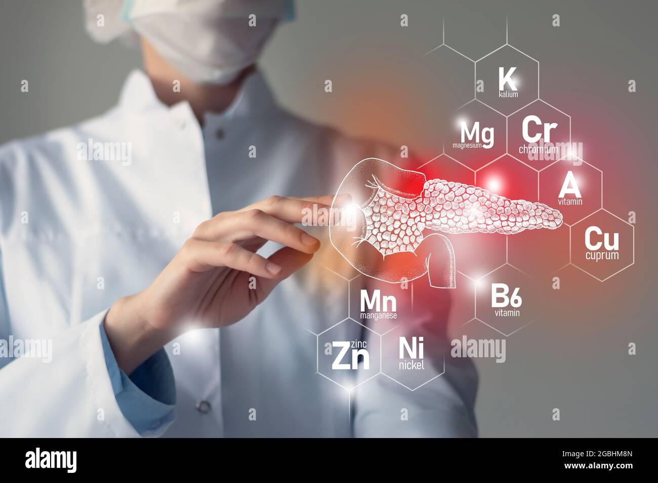 Essential nutrients for Pancreas health including Nickel, Chromium, Cuprum, Manganese. Blurred portrait of doctor holding highlighted red Pancreas. Stock Photo