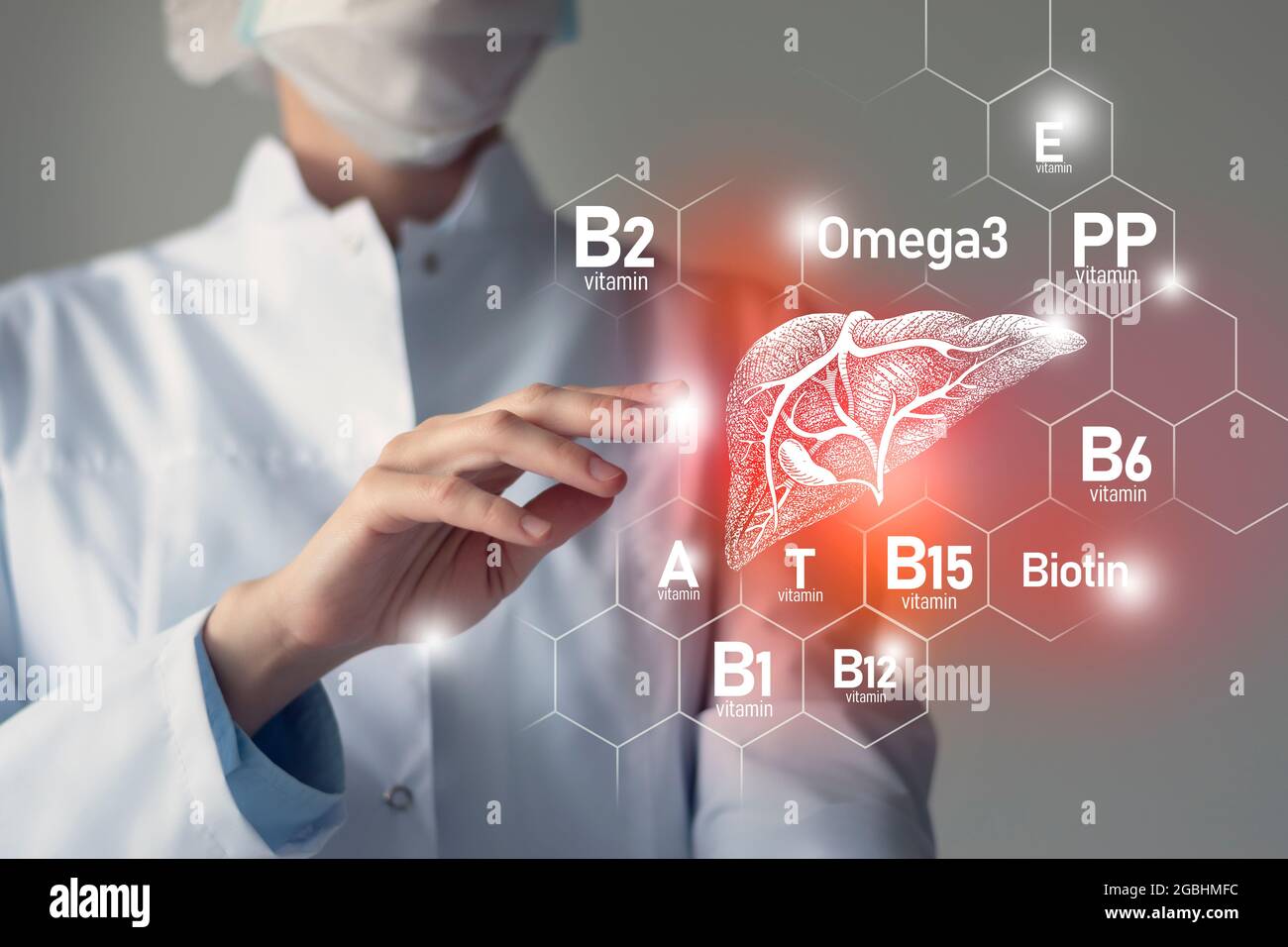 Essential nutrients for Liver health including Omega-3, Carnitine, Biotin, Vitamin PP, Vitamin B. Blurred portrait of doctor holding highlighted red L Stock Photo