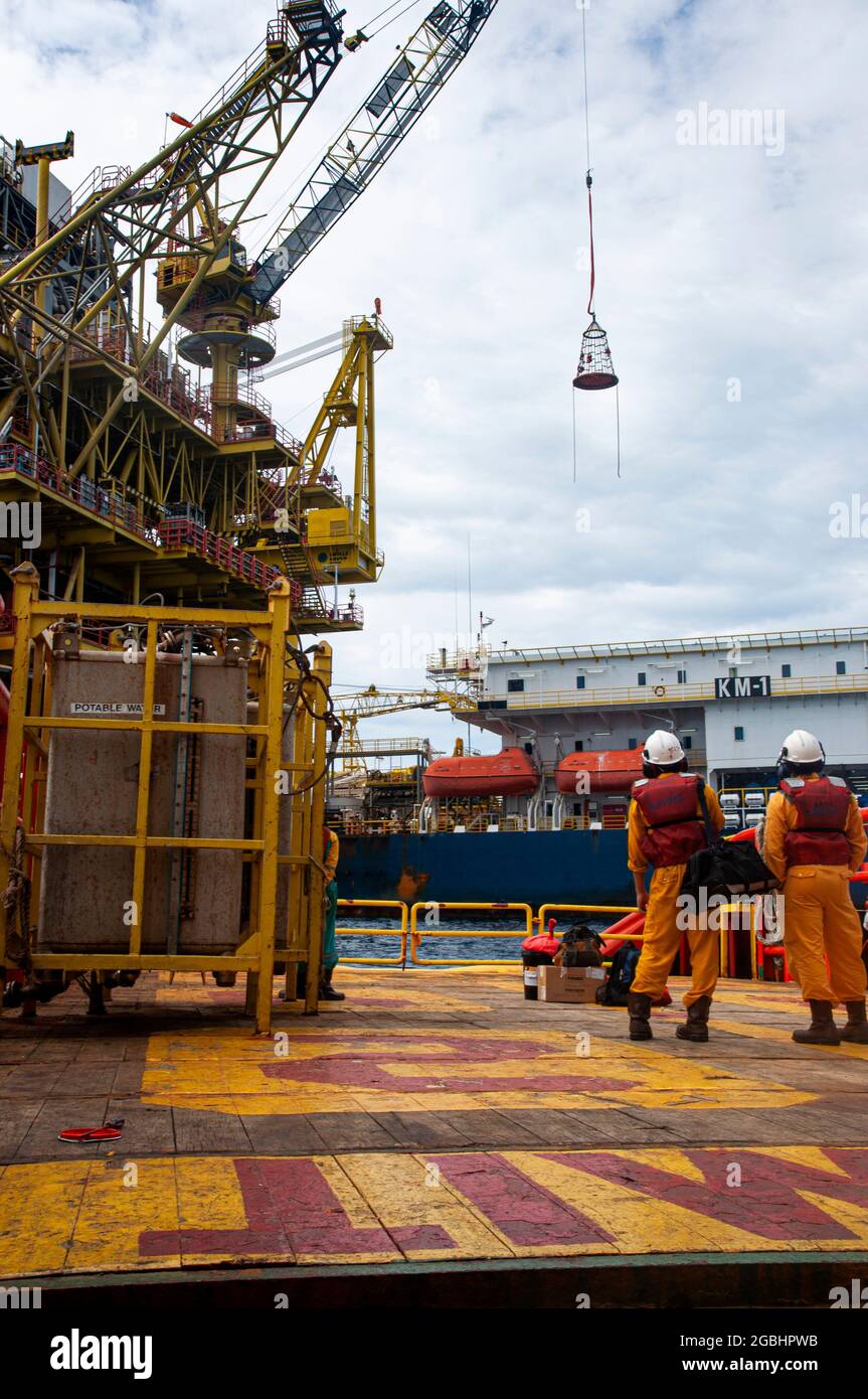 marine crew stand by on deck vessel for personal transfer from platform to vessel Stock Photo