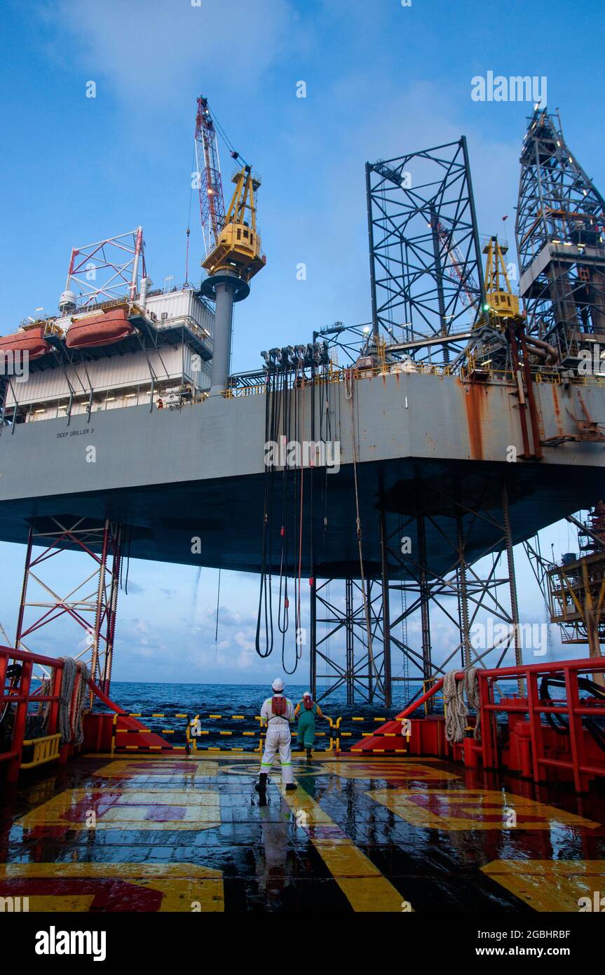 marine crew stand by on deck vessel for personal transfer from platform to vessel Stock Photo