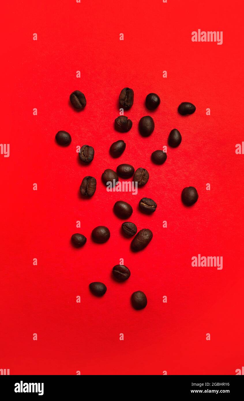 coffee beans close-up on a red background. Stock Photo