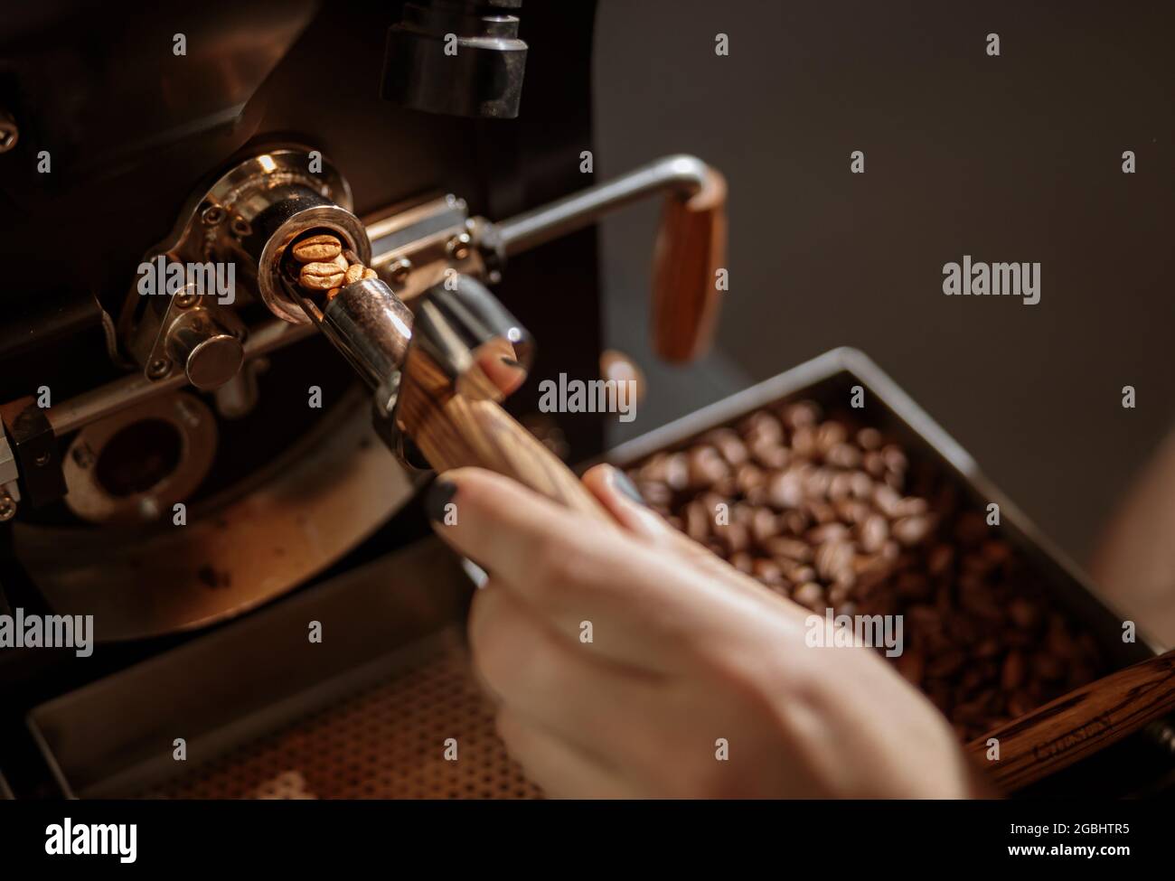 Male worker using industrial coffee roasting machine Stock Photo