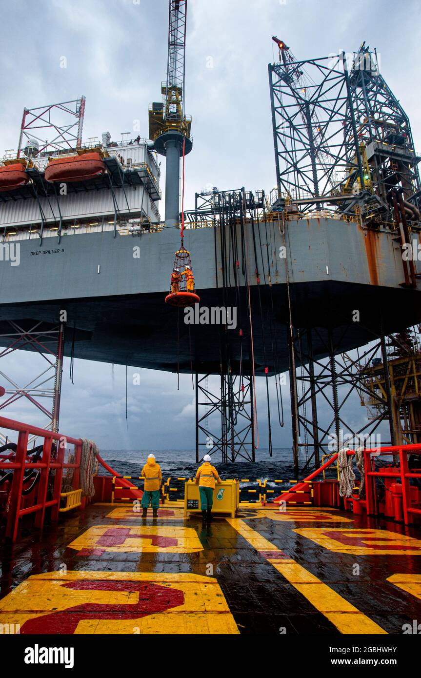 marine crew stand by on deck vessel for personal transfer from platform to vessel Stock Photo