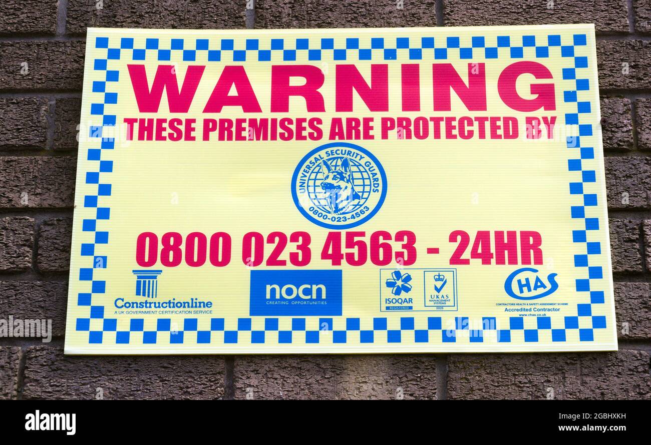 Warning security notice that premises are protected by a security company  in Manchester, England, United Kingdom. Stock Photo