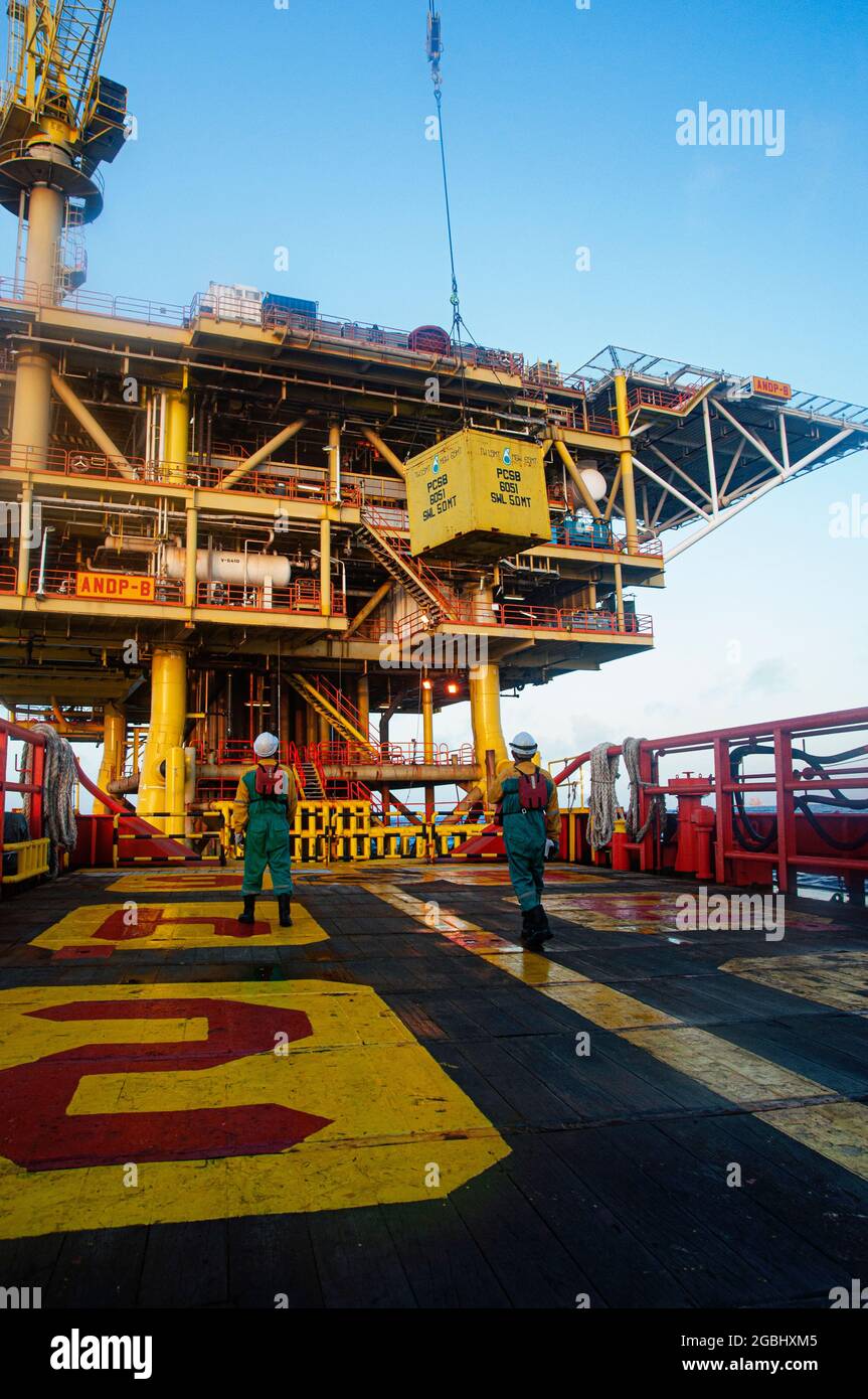 marine crew stand by on deck vessel for personal transfer from platform to vessel Stock Photo