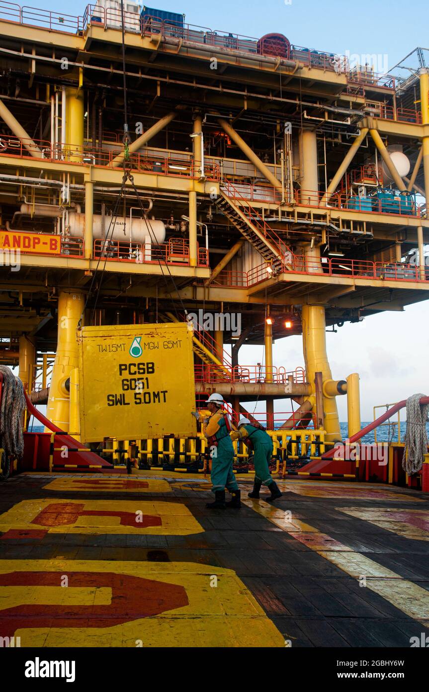 marine crew stand by on deck vessel for personal transfer from platform to vessel Stock Photo
