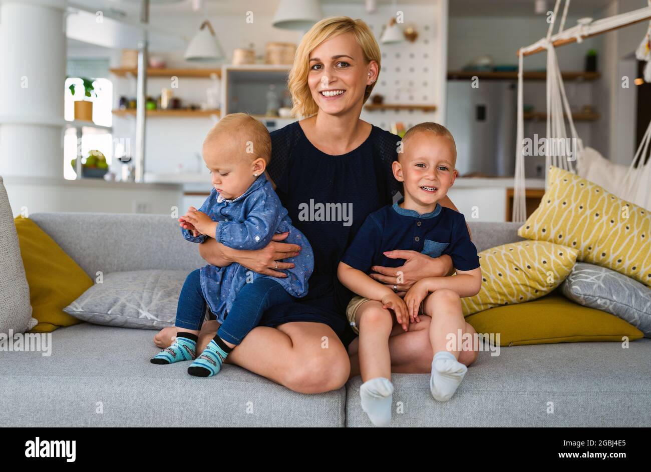 Young mother with two children having fun and love. Stock Photo
