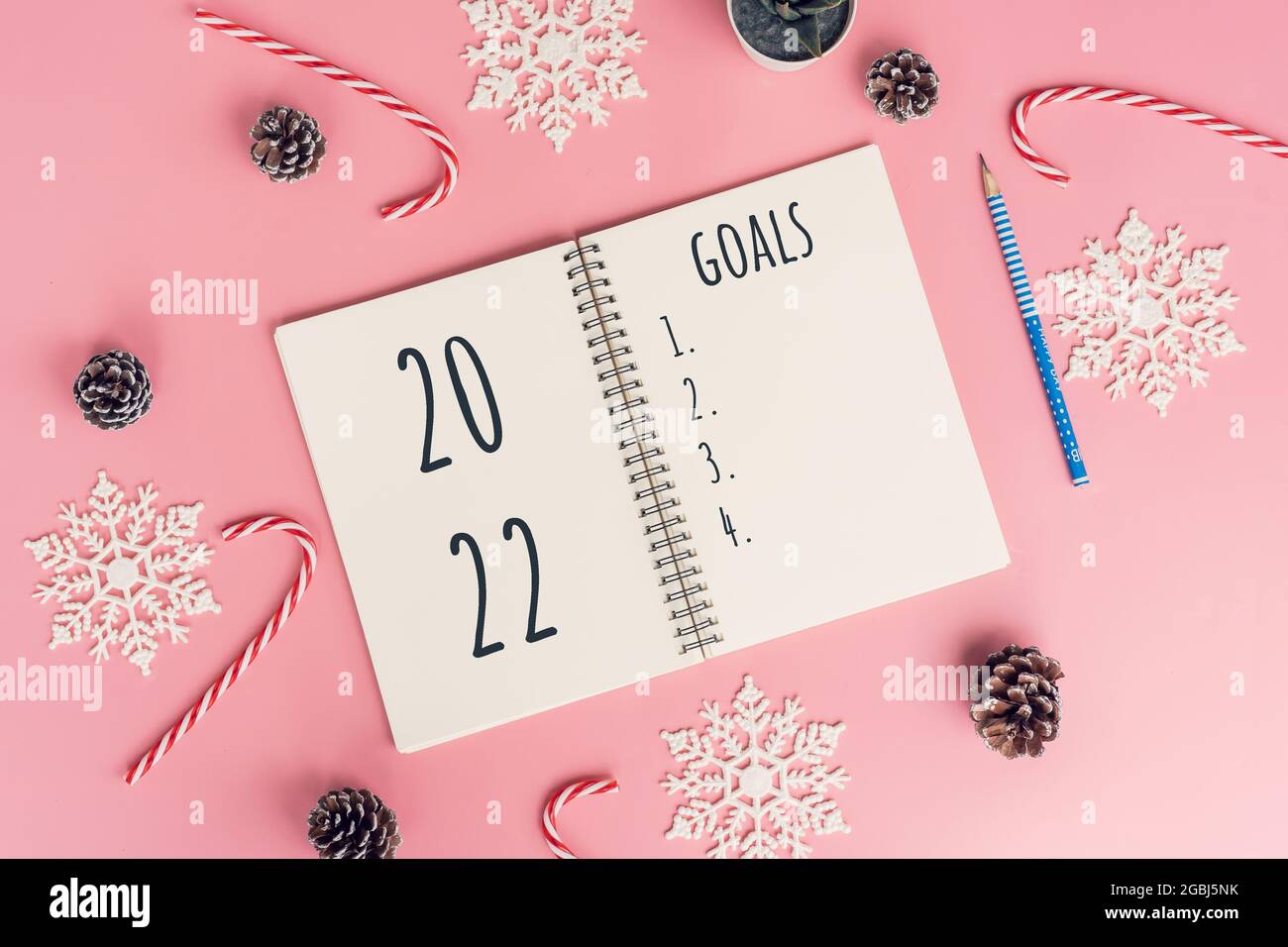 Notebooks with empty goals for 2022 year and christmas decorations on color background Stock Photo
