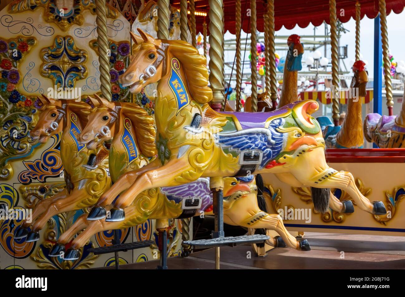 08-04-2021 Portsmouth, Hampshire, UK Traditional wooden carousel horses at a fairground Stock Photo