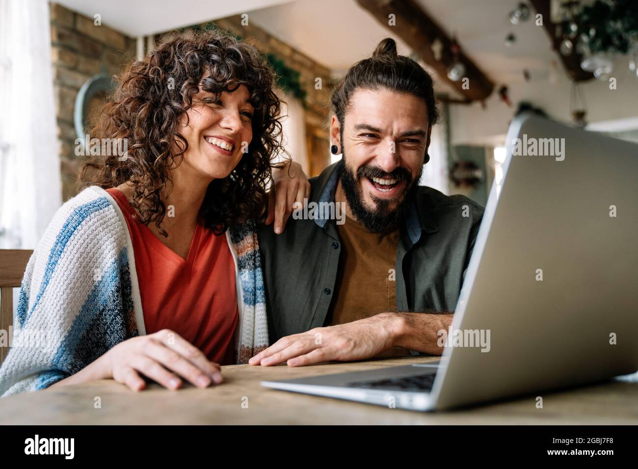 Couple relaxing together at home with computer pc having fun Stock Photo