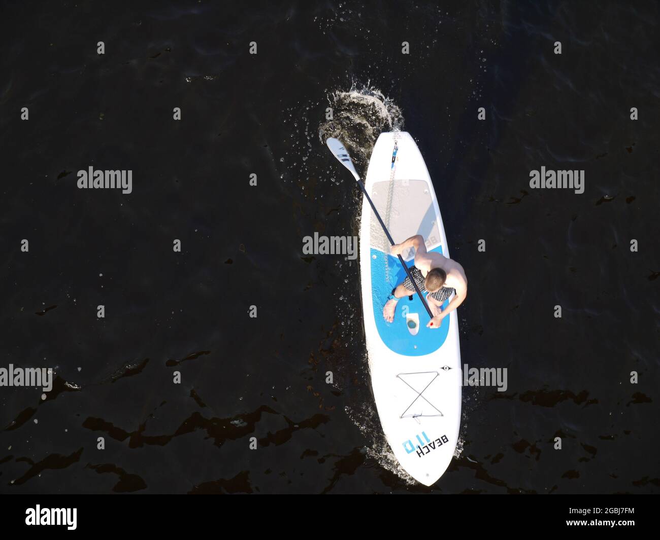 A paddle board viewed from above, on the black waters of the Dnieper River in Kiev, Ukraine Stock Photo