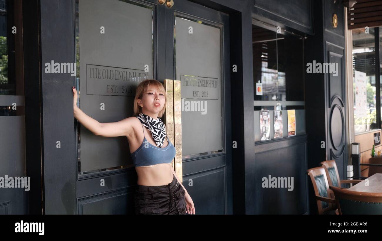 Asian Japanese Model out in front of Cafe on Thong Lo Bangkok Thailand Stock Photo