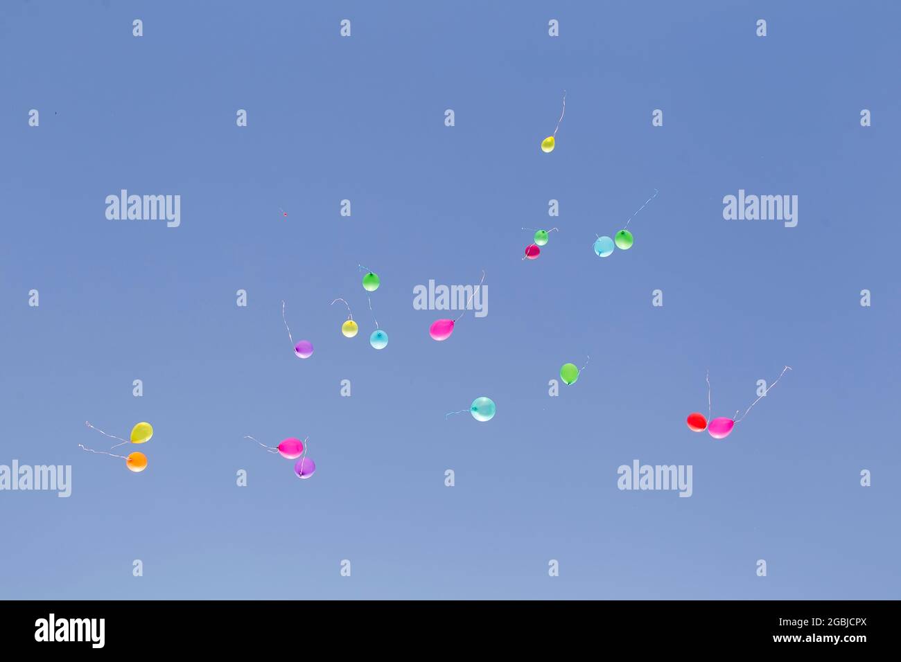 Multicolored balloons against the blue sky. Stock Photo