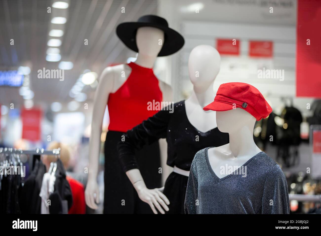 A group of mannequins in a store. Three women manikin in stylish