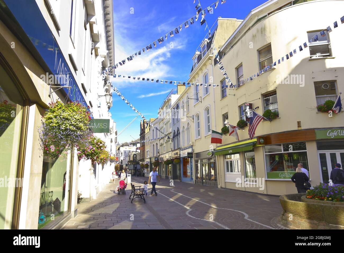 St. Helier, Jersey, Channel Islands, UK - July 6, 2016: King Street shopping area pedestrian zone with bunting and flags, after hours. Stock Photo