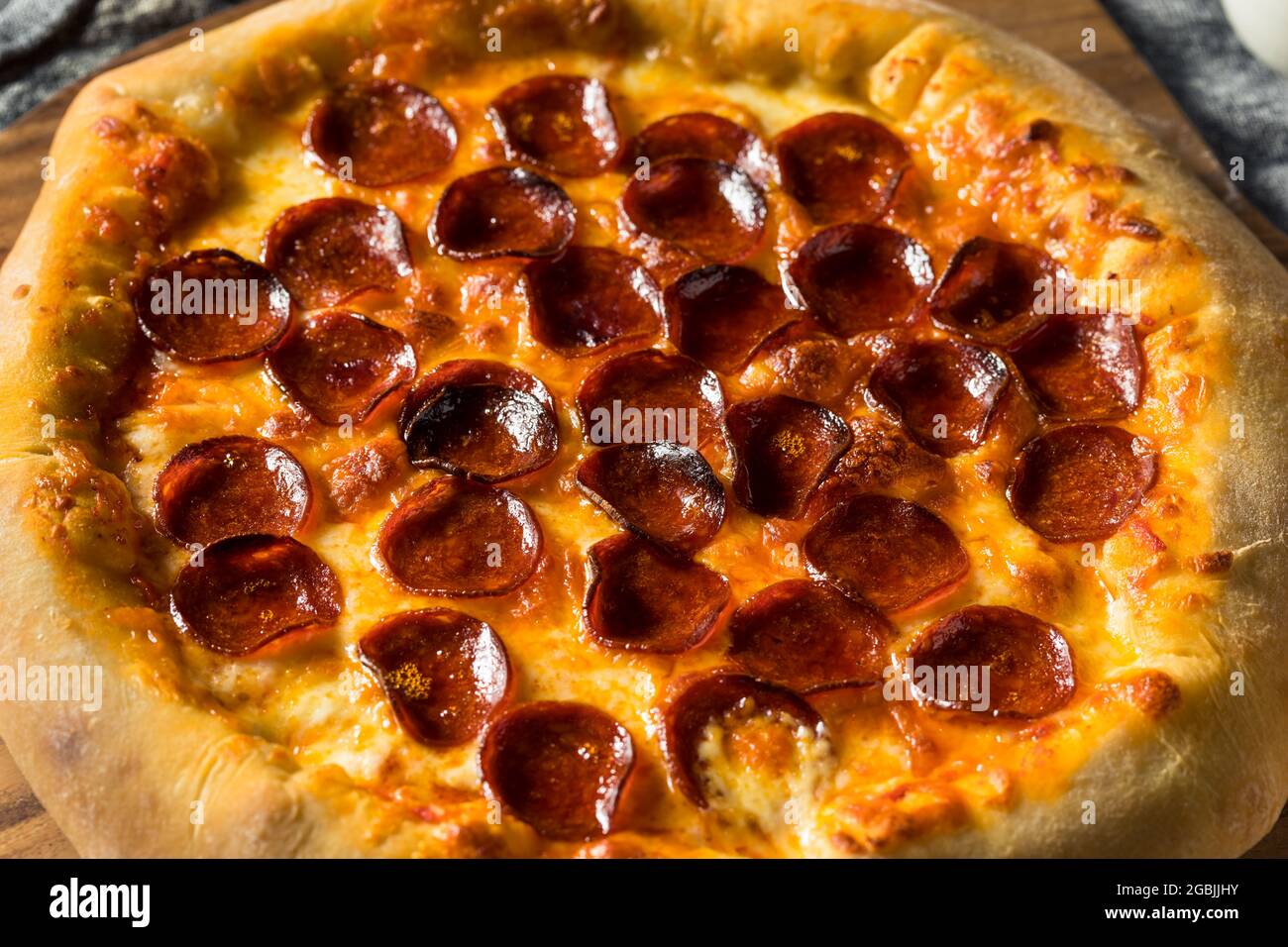 Homemade Pepperoni Stuffed Crust Pizza with Cheese Stock Photo