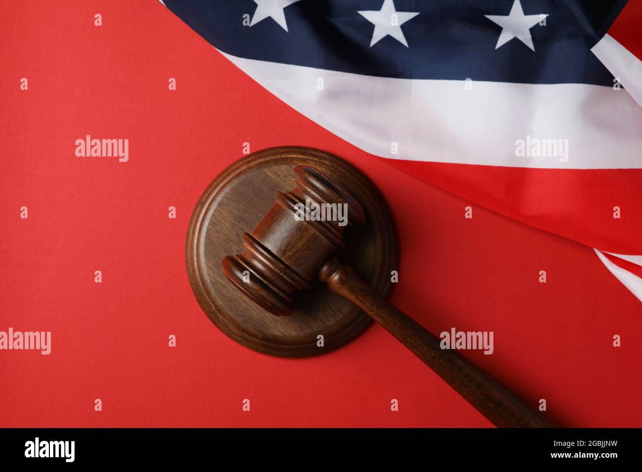 Judge gavel and american flag on red background Stock Photo Alamy