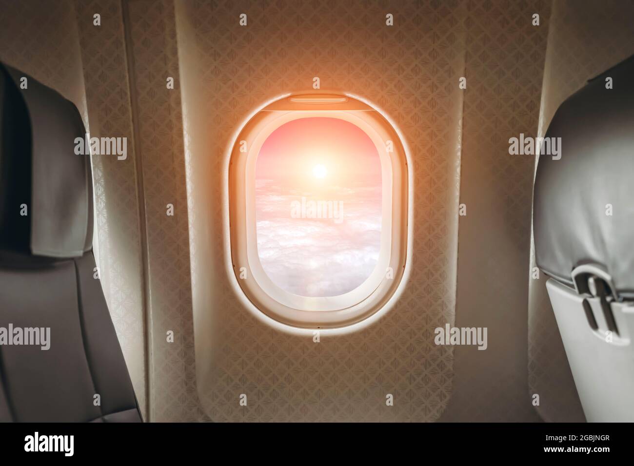 Airplane window in clear sunny weather. Interior of a passenger plane with an open window in flight. High quality photo Stock Photo