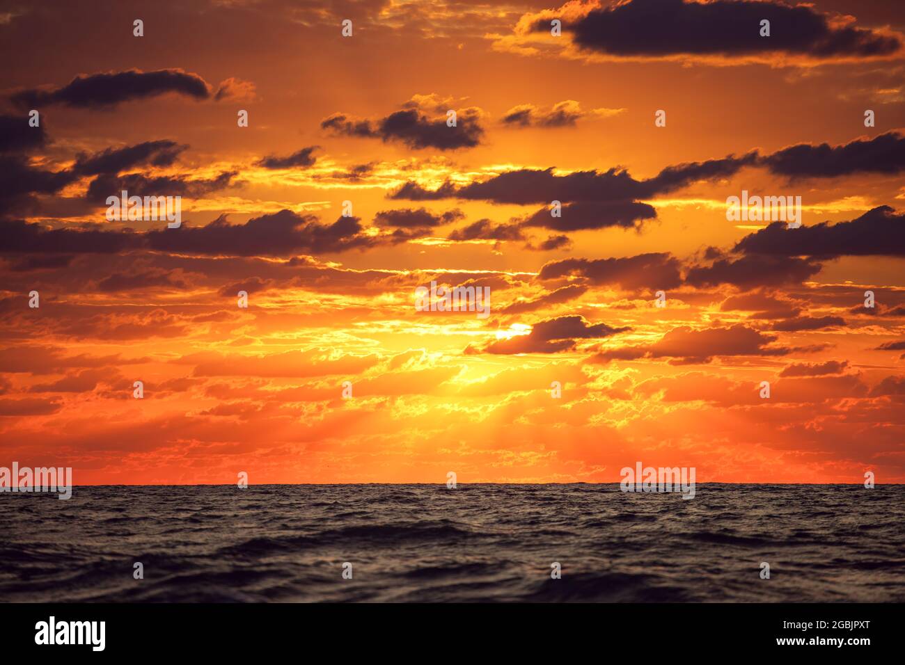 Dramatic cloudscape over the sea, sunrise shot Stock Photo