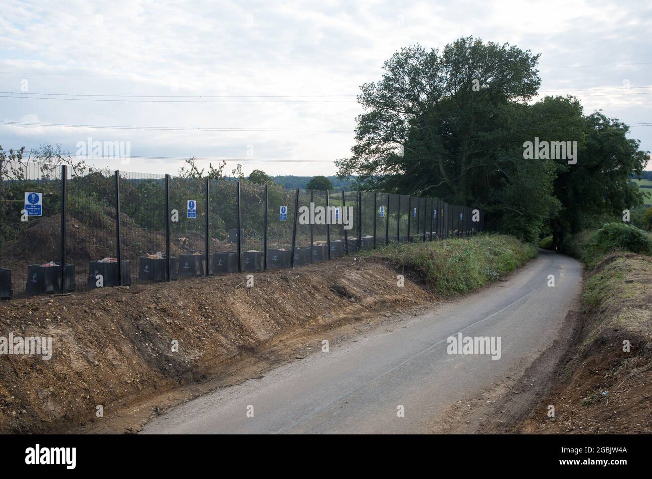 Great Missenden, UK. 3rd August, 2021. A gap indicates where trees from a long row of hundred-year-old oak trees lining Leather Lane were felled in July 2021 to enable the construction of a temporary access road and compound for the HS2 high-speed rail link. Over 40,000 people signed a petition in order to try to save the oak trees along the wildlife-rich ancient country lane. Credit: Mark Kerrison/Alamy Live News Stock Photo