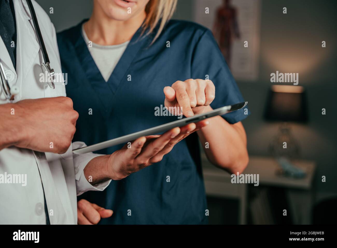 Close up caucasian nurse chatting with male doctor in clinic Stock Photo