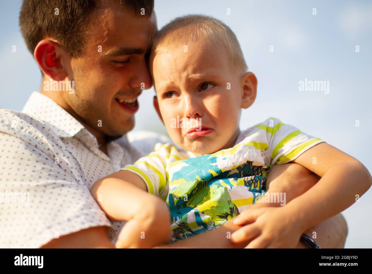 Happy dad comforts his little crying son.Paternity Stock Photo - Alamy