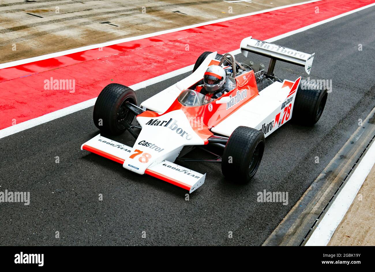 Warren Briggs driving his  McLaren M29, down the International Pit Lane, at the end of the Murray Walker Memorial Trophy for Masters Historic F1 Cars. Stock Photo