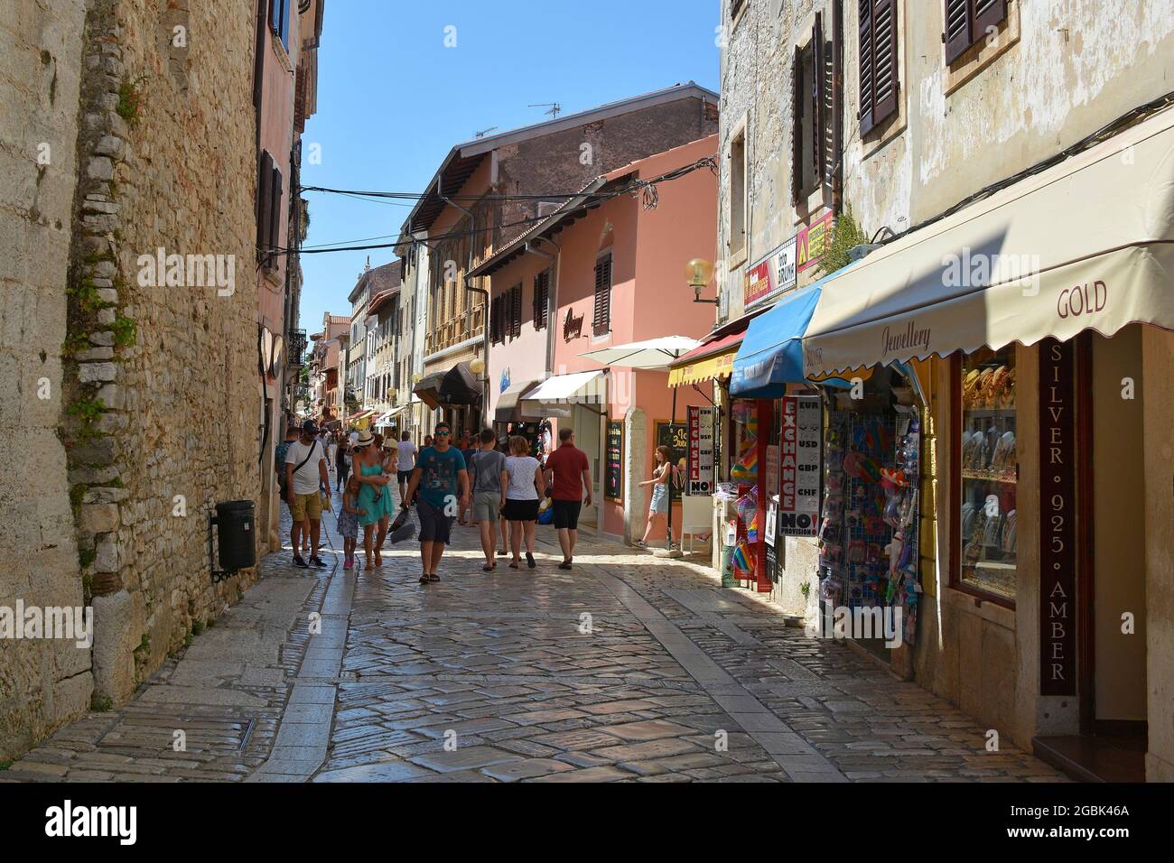Porec, Croatia- July 10th 2021. A street busy with shops and tourists in the historic medieval coastal town of Porec in Istria, Croatia Stock Photo