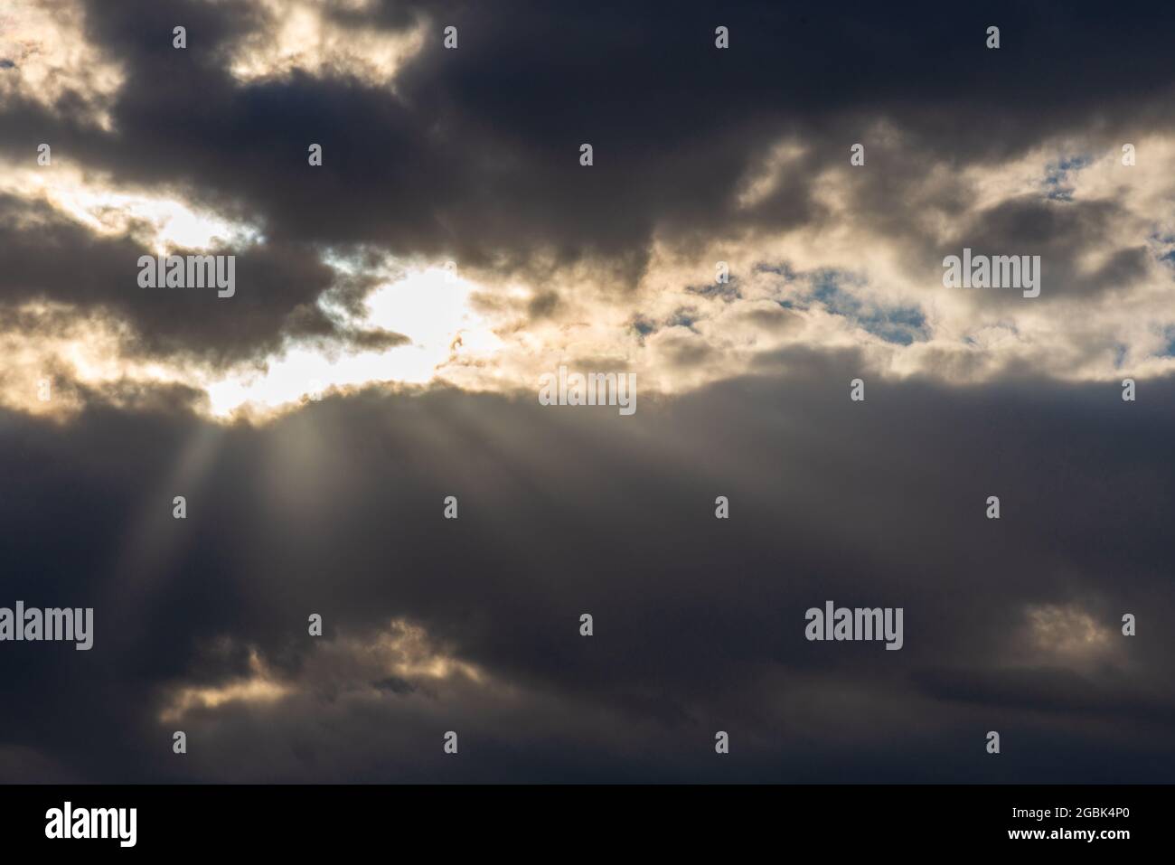 Rays of light shining throug dark clouds.Beautiful dramatic sky with sun rays.dramatic sky sun rays. Stock Photo