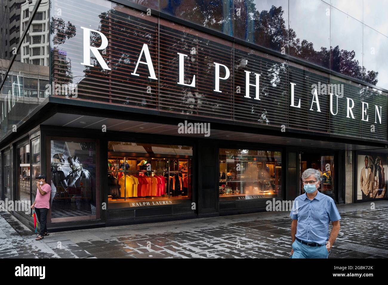 A pedestrian walks past the American fashion brand Ralph Lauren store and  in Hong Kong. (Photo by Budrul Chukrut / SOPA Images/Sipa USA Stock Photo -  Alamy