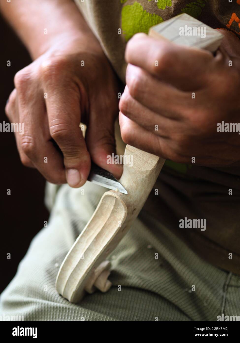 Luthier working on violin head and curl Stock Photo