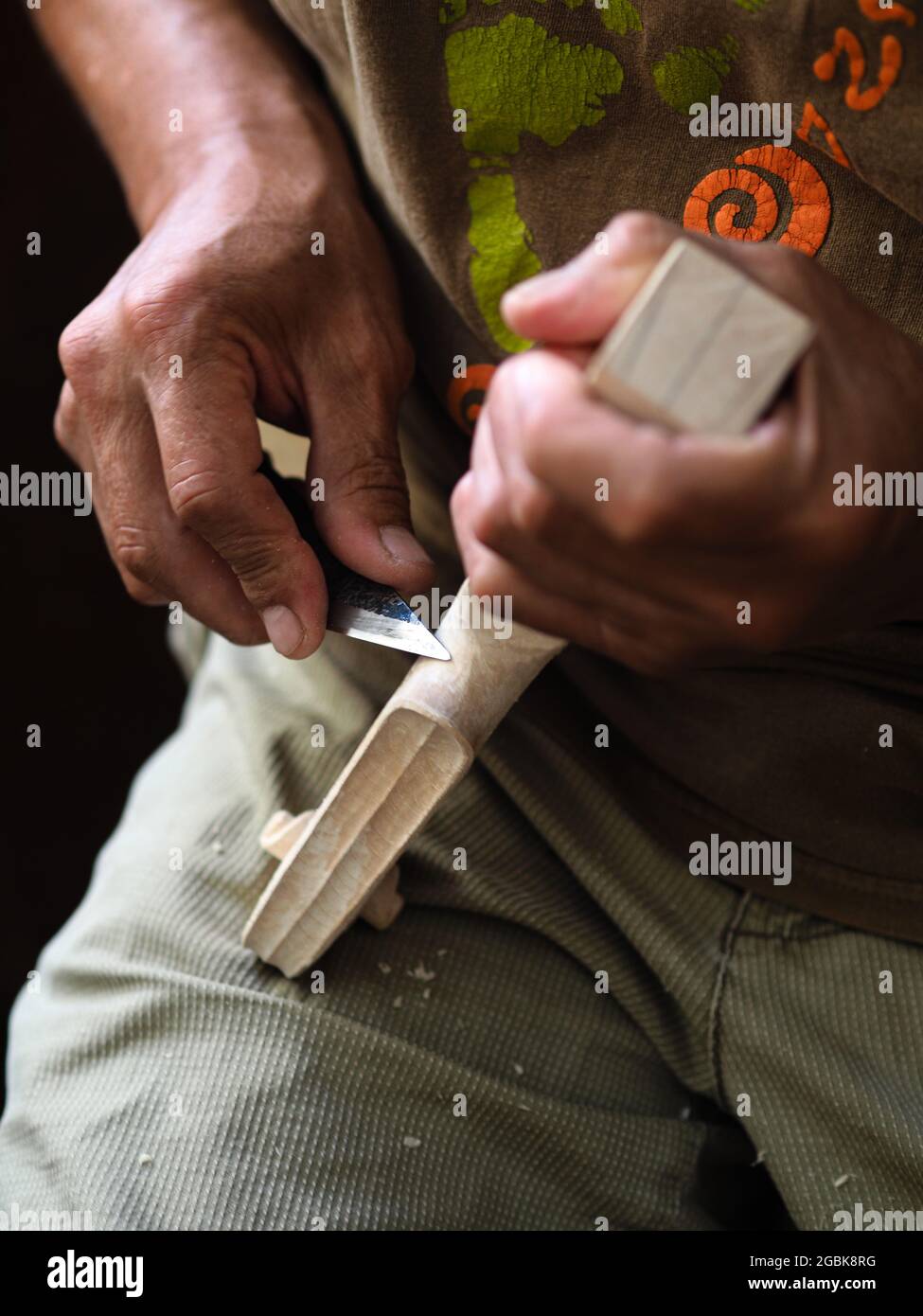Luthier working on violin head and curl Stock Photo
