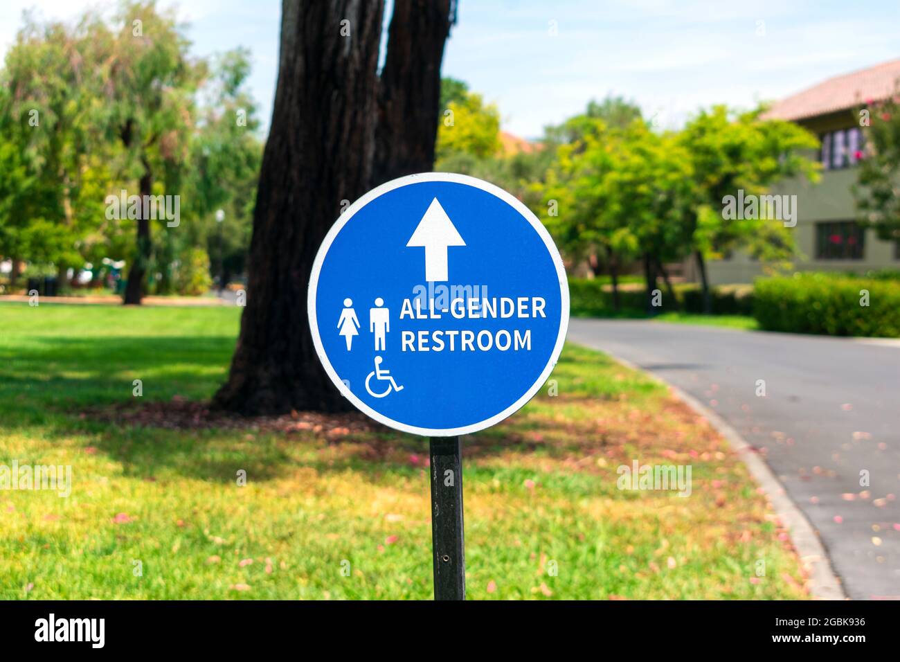 All Gender Restroom outdoor sign with directional arrow. ADA compliant gender neutral outdoor signage. Stock Photo