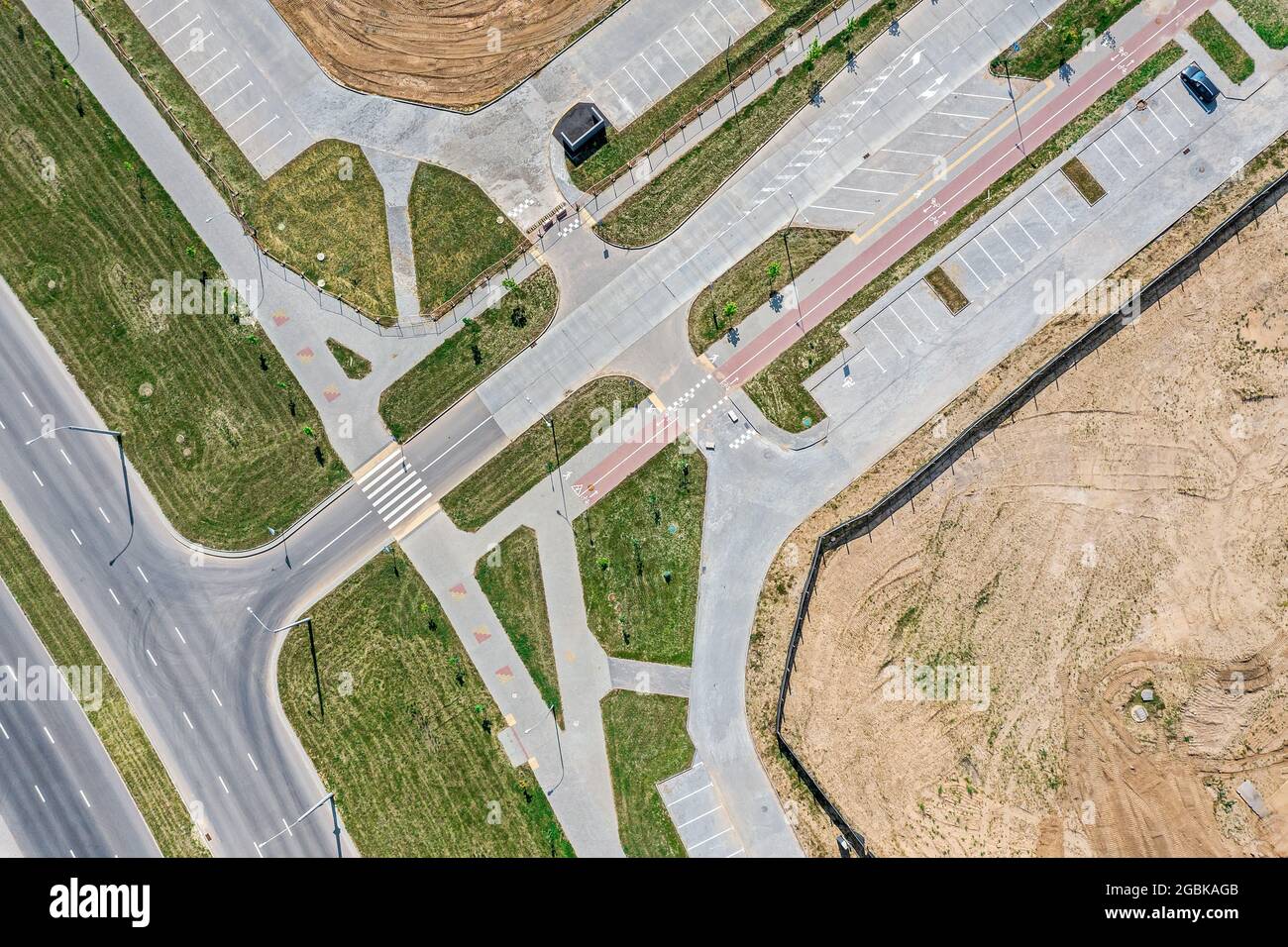 road intersection, sidewalk and parking lots, view from above with drone. newly constructed urban road Stock Photo