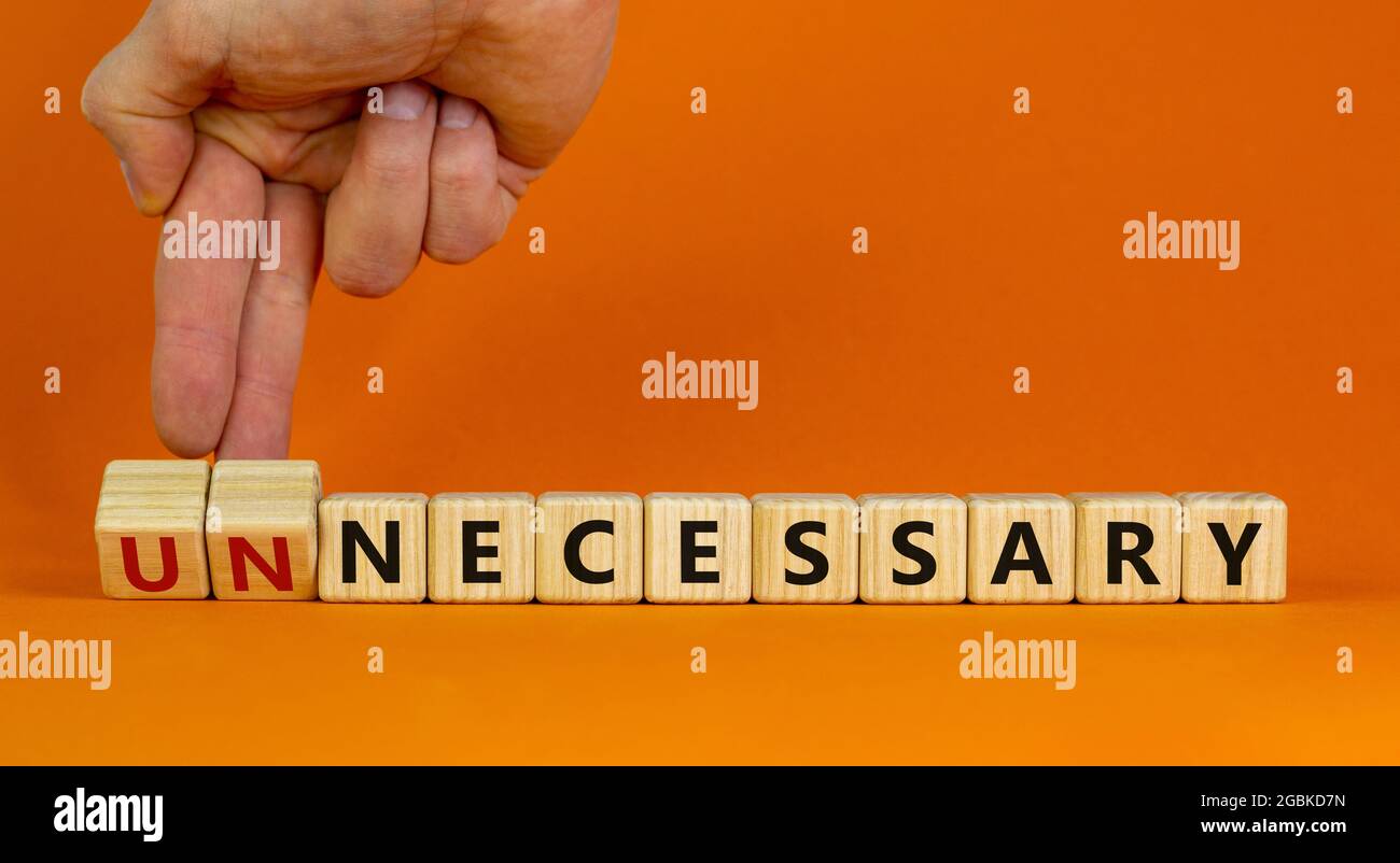 Necessary or unnecessary symbol. Businessman turns wooden cubes 