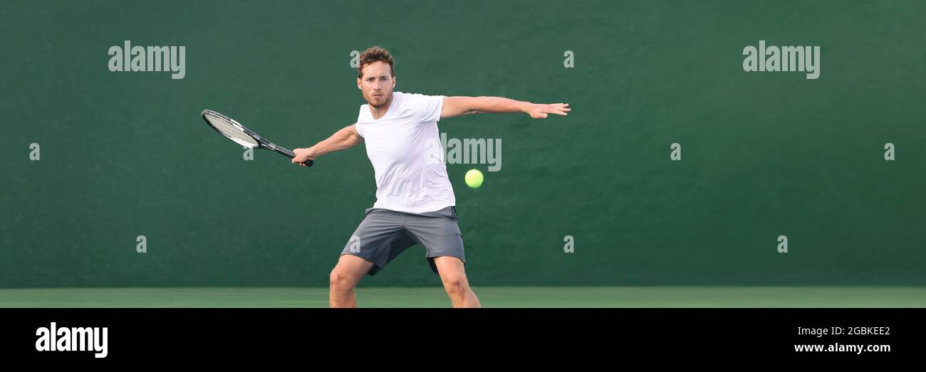 Tennis player man header banner hitting ball with racket on green horizontal copy space background. Sports athlete training forehand grip technique on Stock Photo