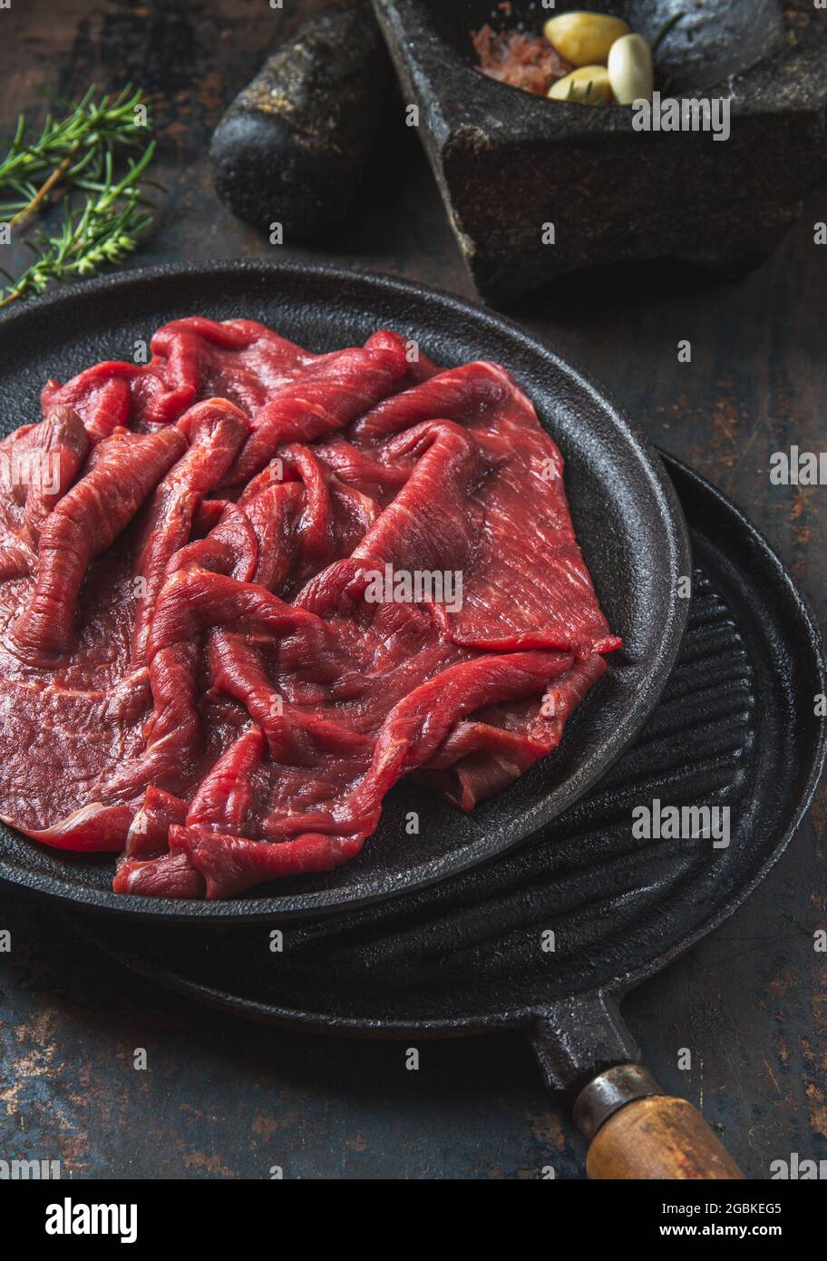 Beef tenderloin with herbs and spices on cast iron plate Stock Photo