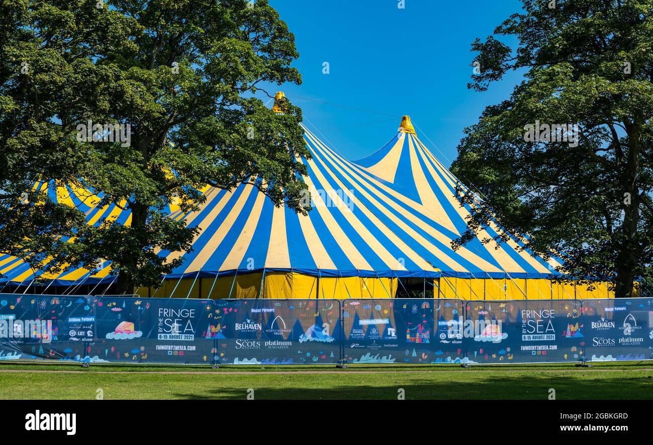 North Berwick, East Lothian, Scotland, United Kingdom, 4th August 2021. Fringe-by-the-Sea preparations: A striped big top tent is erected in Lodge Grounds as the main venue for the seaside festival which was cancelled last year due to the Covid-19 pandemic Stock Photo