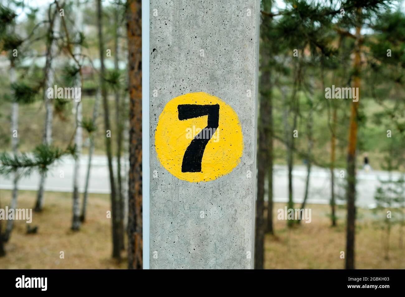 The number 7 on the gray pillar is painted with paint. Stock Photo