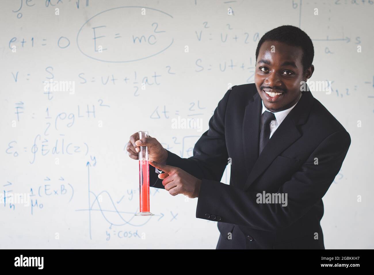 African teacher is teaching science subjects through experimental methods, showing students to