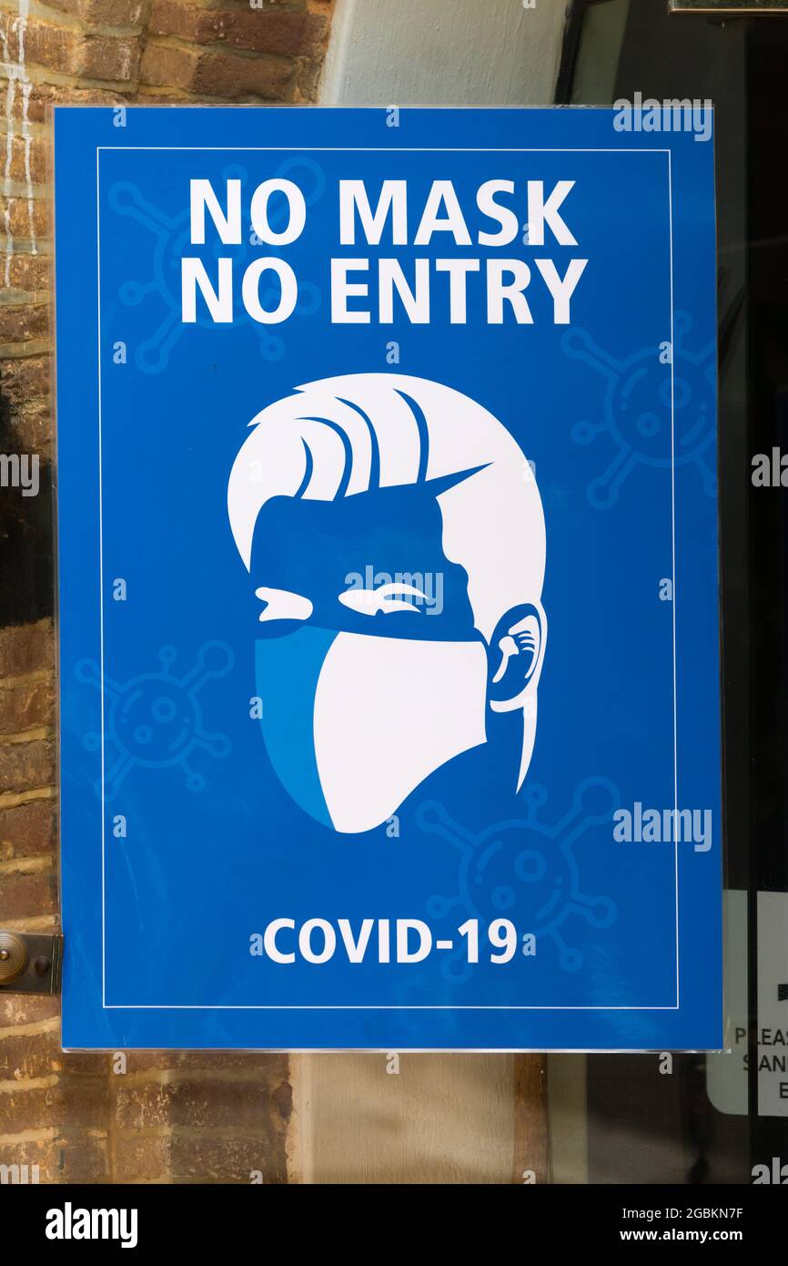 sign or poster on a glass door for Covid 19 with text or words no mask no entry concept pandemic health information in South Africa Stock Photo