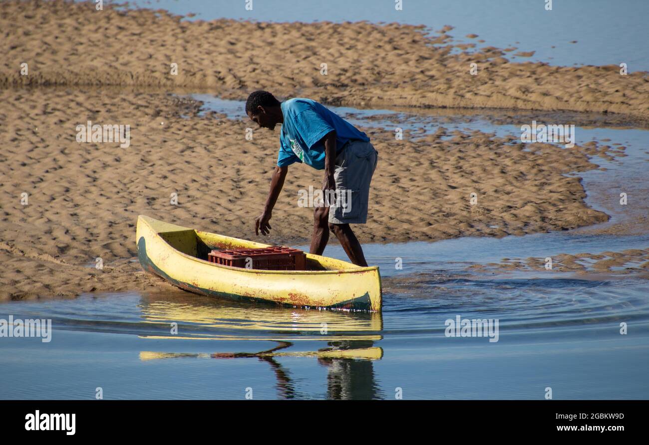 Plettenberg Bay, South Africa - an unidentified subsistence fisherman pumps mud prawns and collect bait for a day's fishing on the lagoon Stock Photo