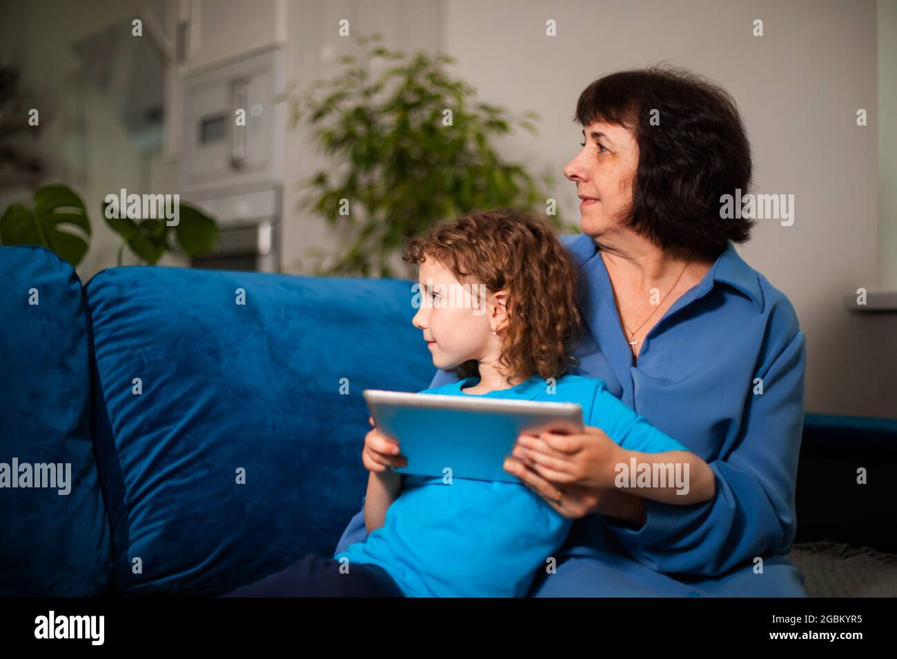 Grandma discovers means of online communication together with her granddaughter Stock Photo