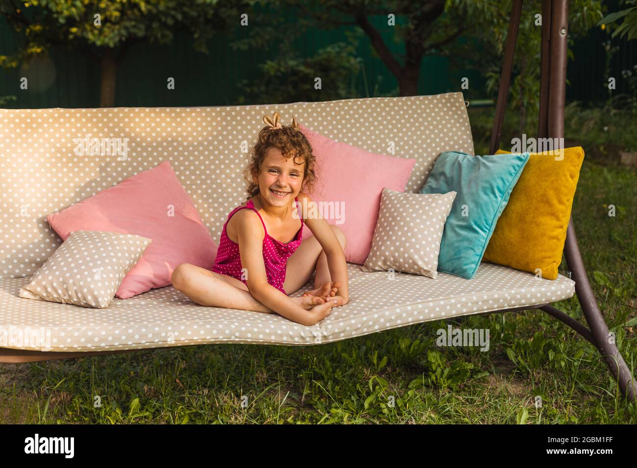 Little angel girl smiling, joyfully looking at the camera Stock Photo ...