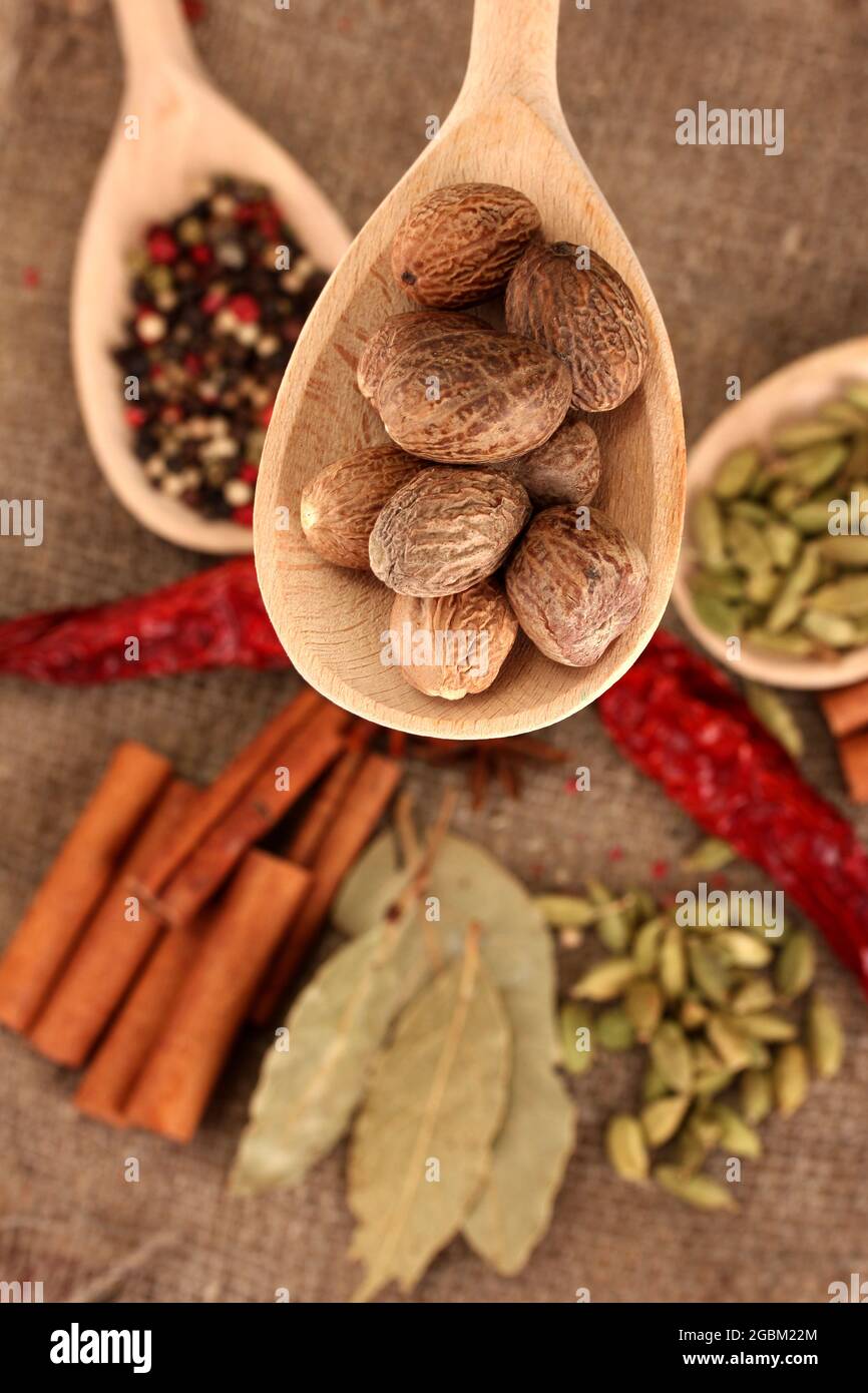 Nutmeg and other spices on sackcloth background Stock Photo Alamy