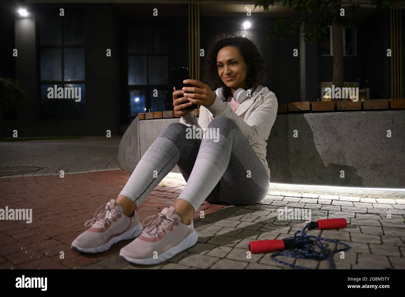 Woman swipes on smartphone smiling hi-res stock photography and images ...