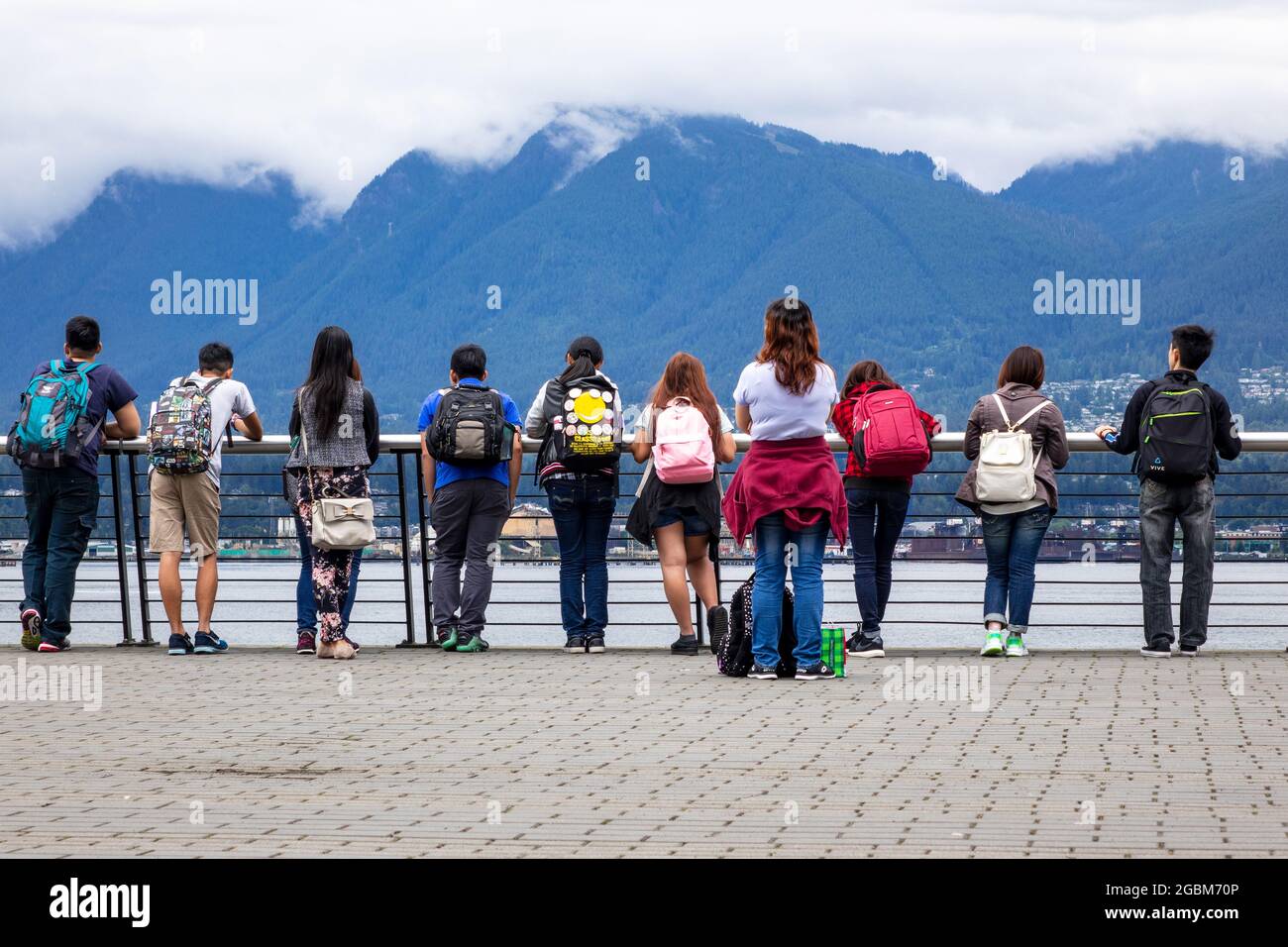 Teenage School Children Tourists Looking At Vancouver Harbour At The Vancouver Convention Centre Stock Photo