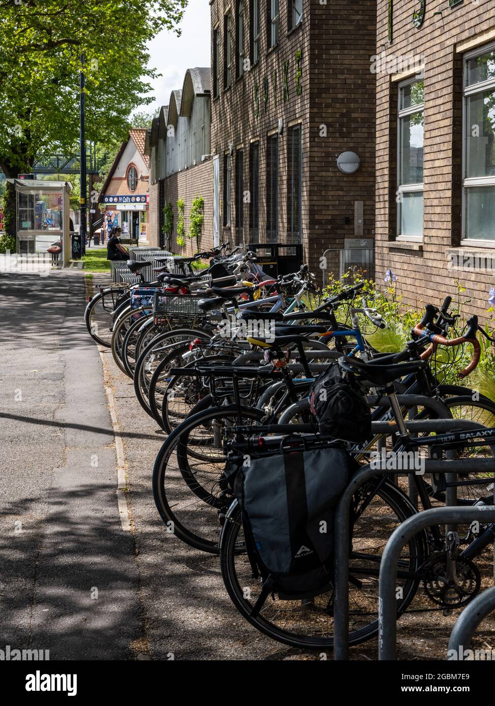 A row of 'Sheffield stand' cycle racks placed prominently and conveniently outside the main entrance of a building, with space for non-standard cycle Stock Photo